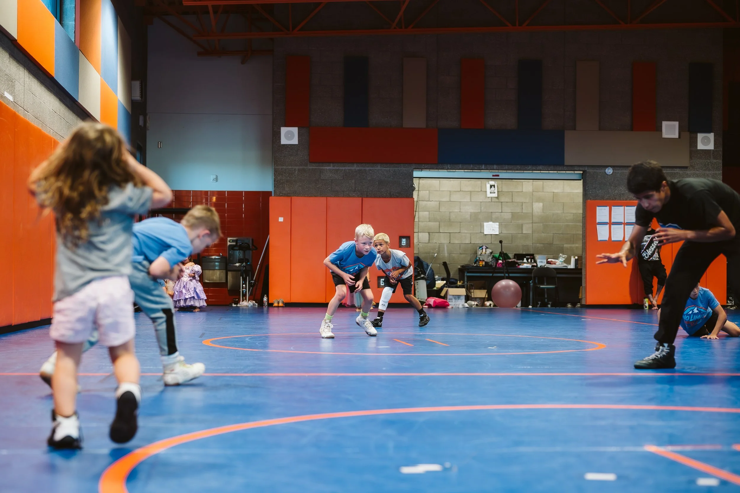 Wrestling coach supporting a young athlete through fear, pressure, and confidence challenges during competition.