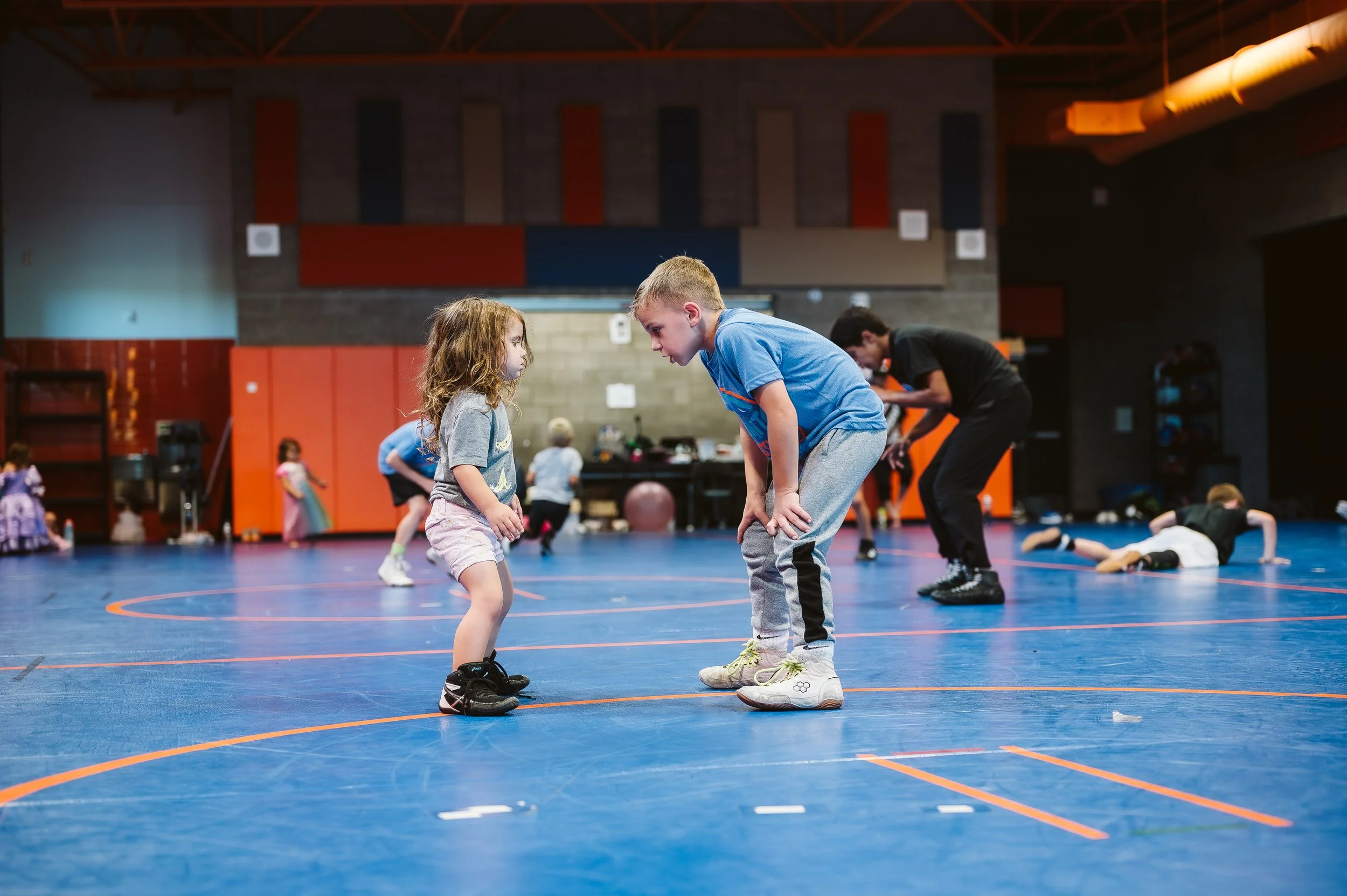Coach guiding a structured youth sports practice focused on quality training rather than excessive volume.