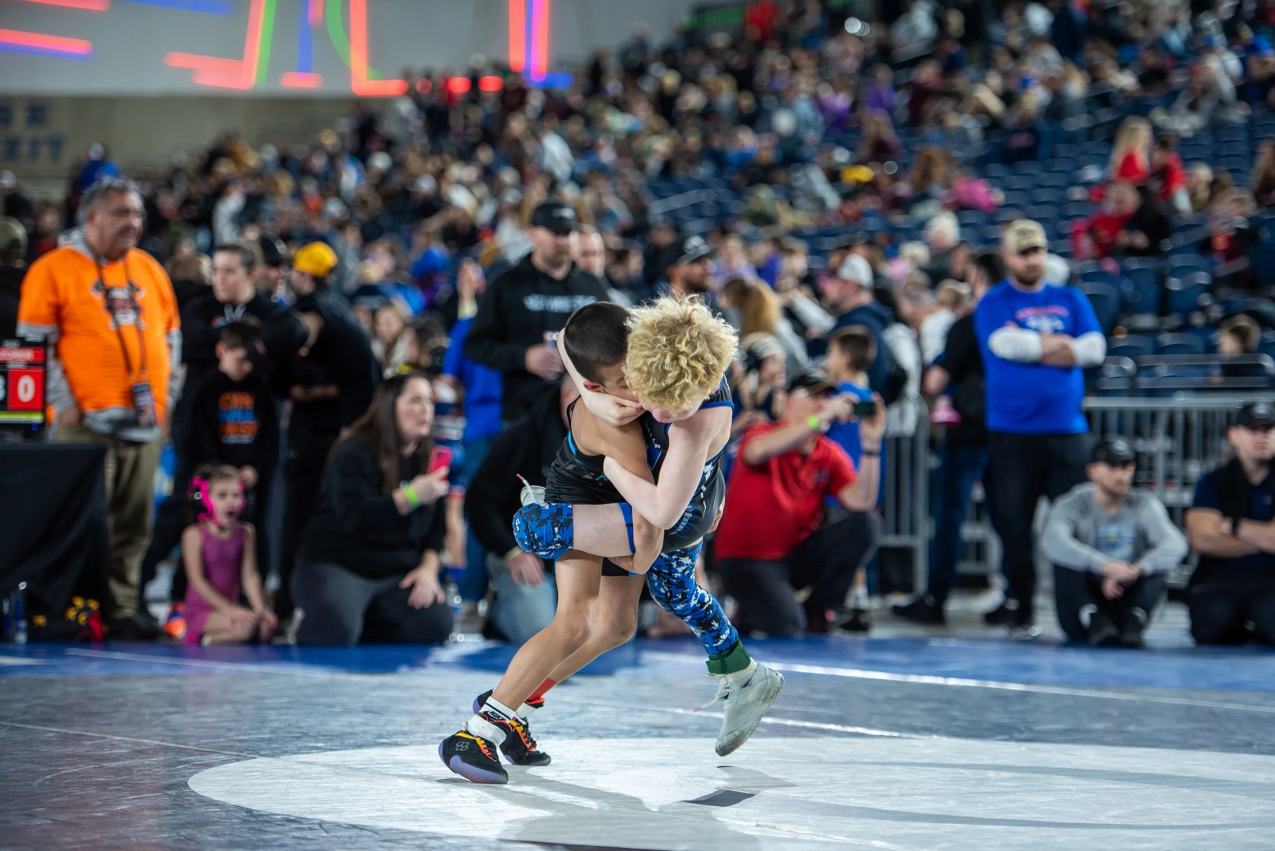 Youth wrestlers competing in tournament match after strong summer recovery, sleep discipline, and offseason performance development