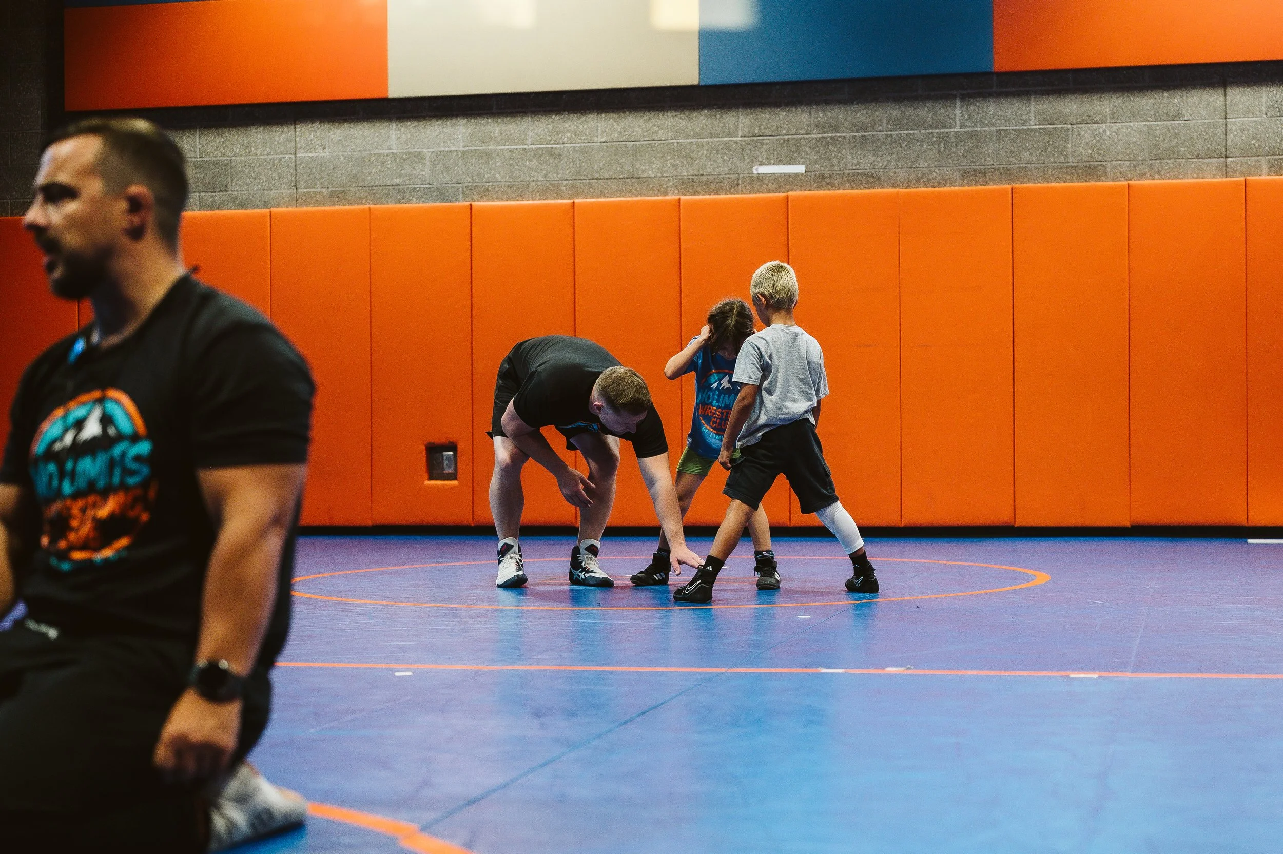 Young wrestlers practicing hard during training at No Limits Wrestling Club, learning technique and building confidence through effort.