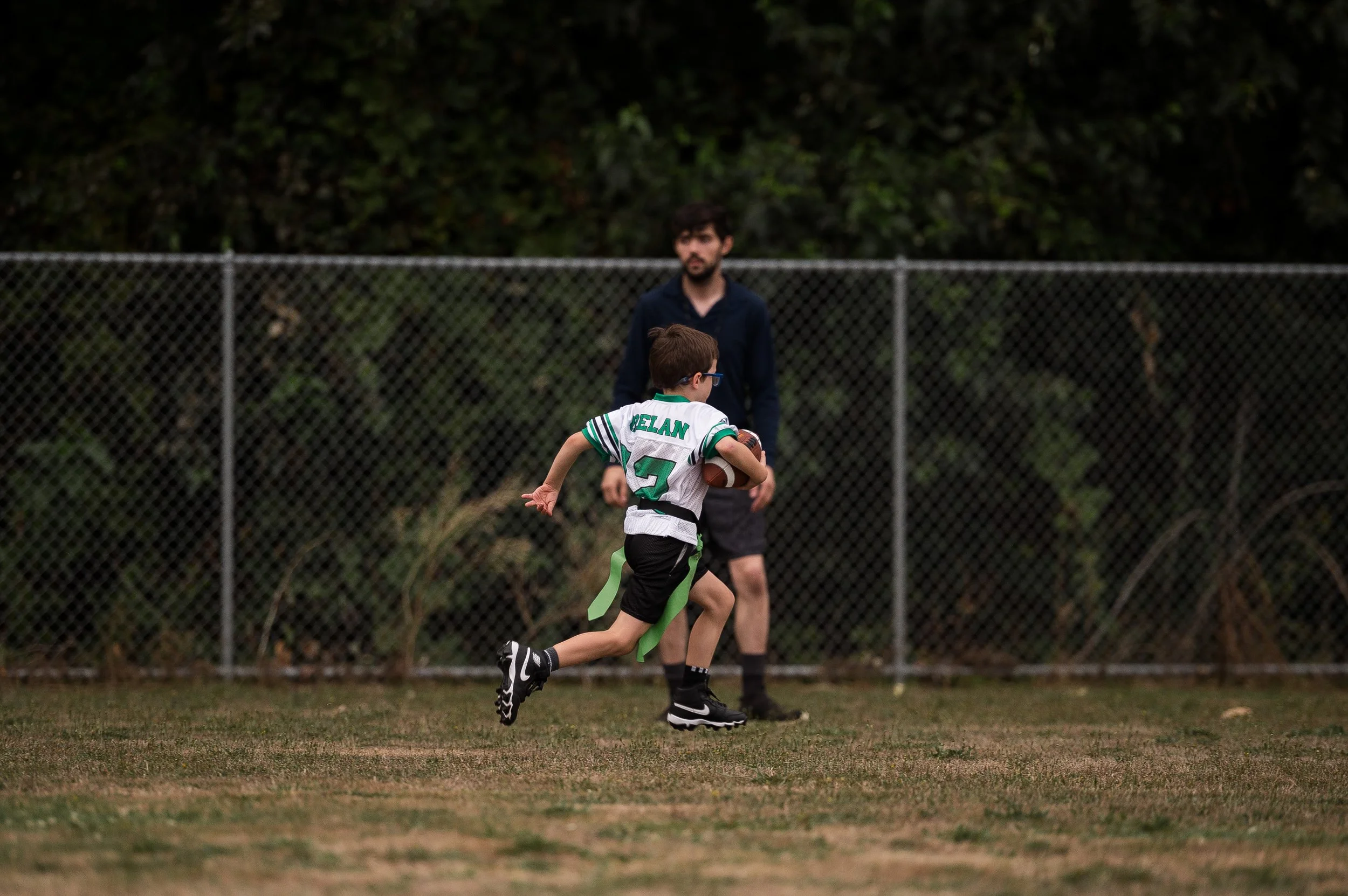 Youth wrestler sitting mat-side after a tough match, learning resilience and emotional control during a high-pressure tournament in Washington.