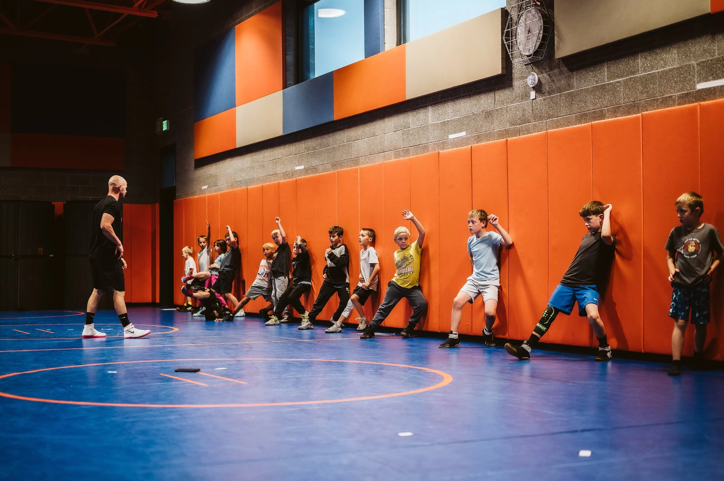 Youth wrestling team preparing together at a tournament, emphasizing long-term development, perseverance, and growth through adversity.