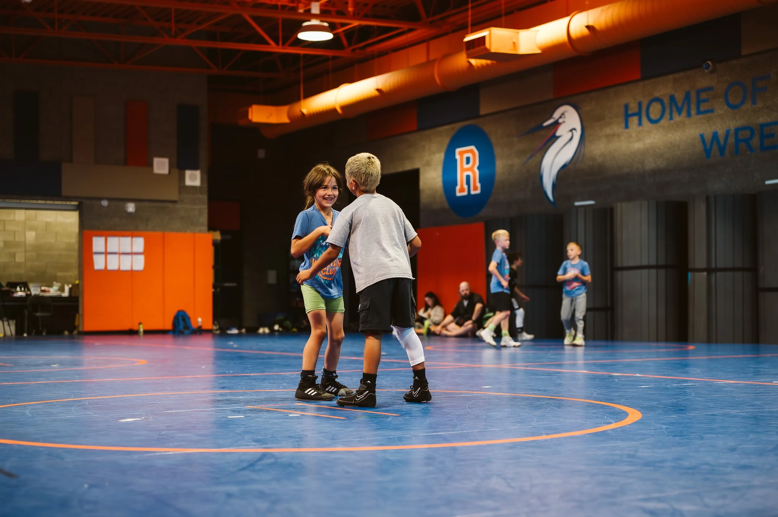 Youth athlete receiving calm coaching support to maintain emotional regulation during training.