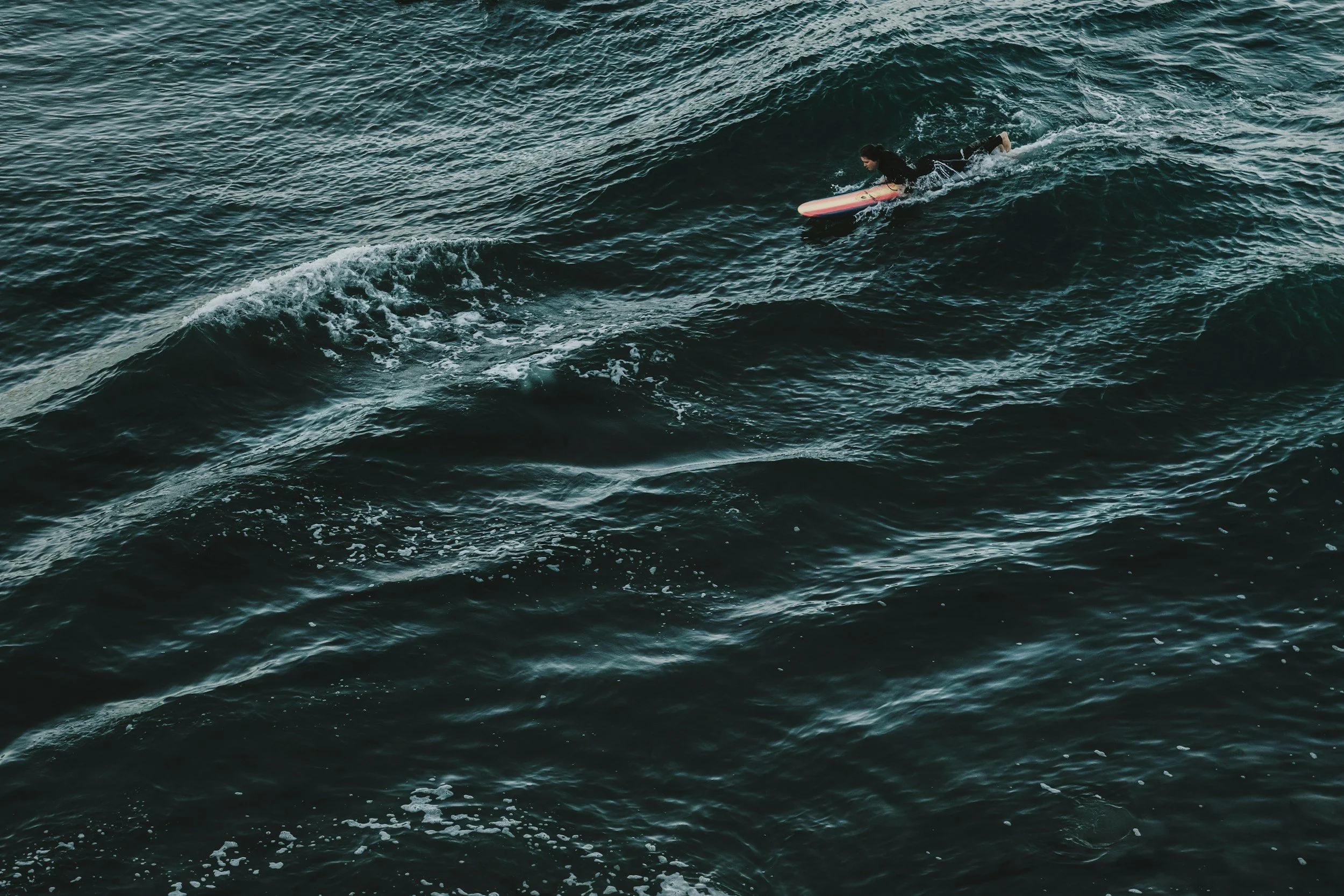 A woman surfing a wave.