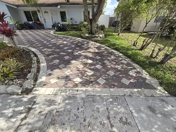 Outdoor living entrance featuring a decorative paver driveway in North Lauderdale, FL