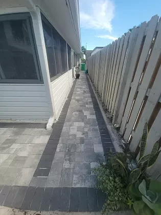 Modern patio pavers installed over grass and concrete in Broward County, FL