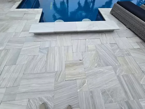 Paver walkway adjacent to pool deck after restoration work in Palm Beach, FL