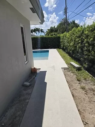 Paver walkway bordering the pool deck after transformation in Jupiter, FL