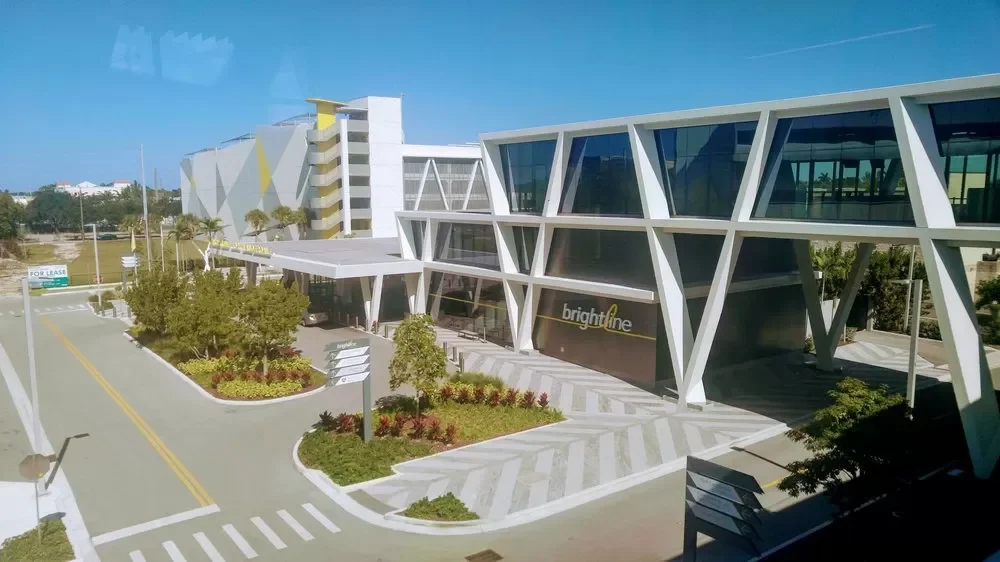 Modern commercial building with angular design, large glass windows, and a sign that says 'brightline.'