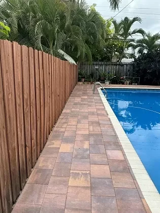 Paver walkway connecting driveway and pool deck in Palm Beach, FL