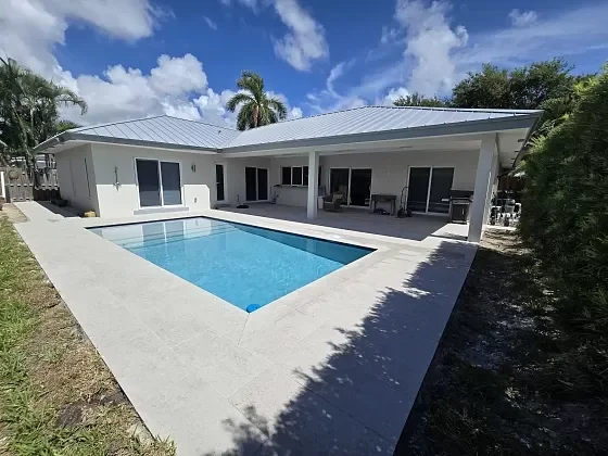 Outdoor living patio and pool deck redesigned with clean paver lines in Jupiter, FL