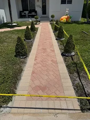 Paver walkway connecting driveway to home entrance in North Bay Village, FL