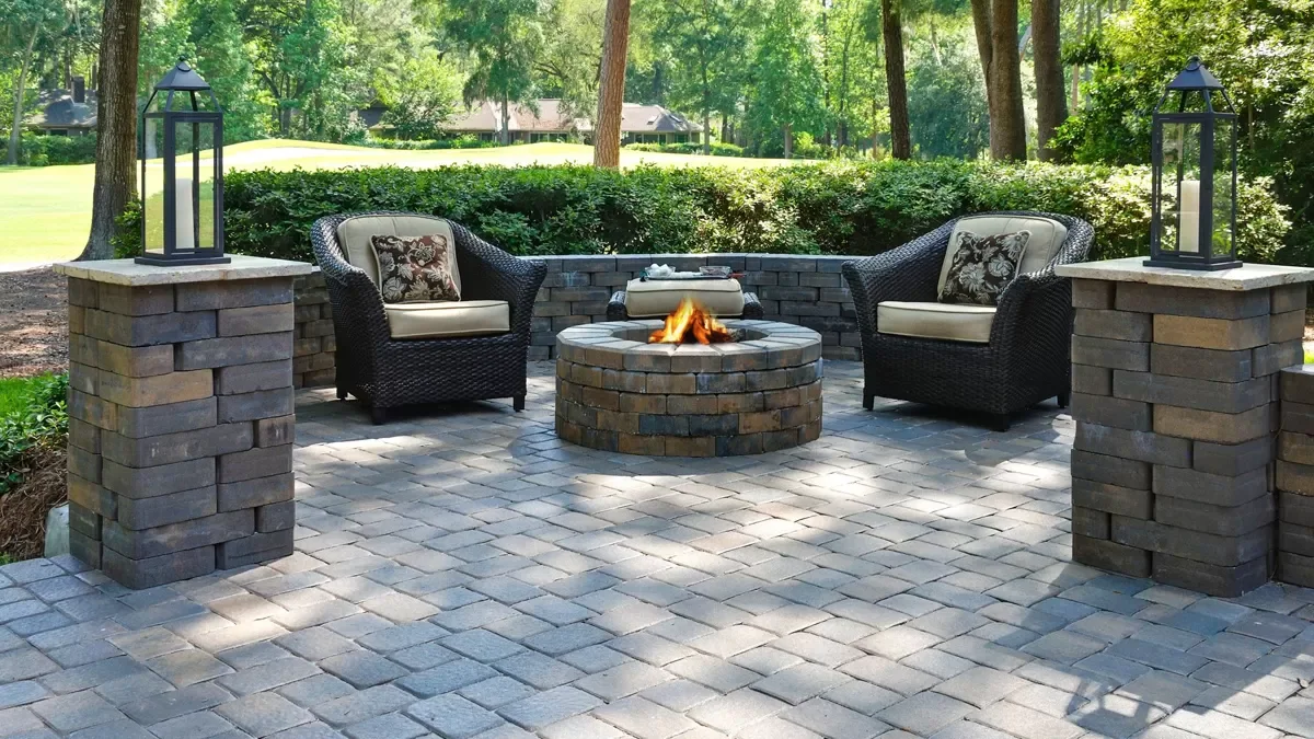 Outdoor living patio with fire pit and seating wall in Jupiter, FL