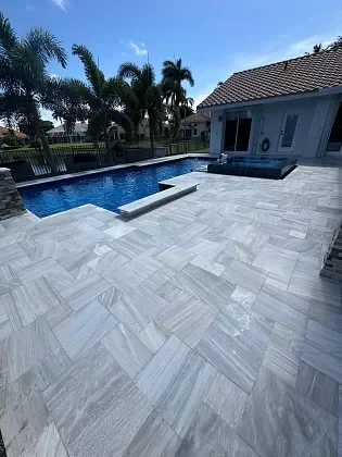 Pool deck surface after professional paver cleaning in Palm Beach, FL