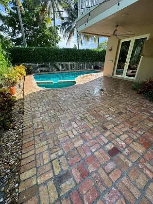 Outdoor living space featuring restored paver driveway and walkway in Lighthouse Point, FL