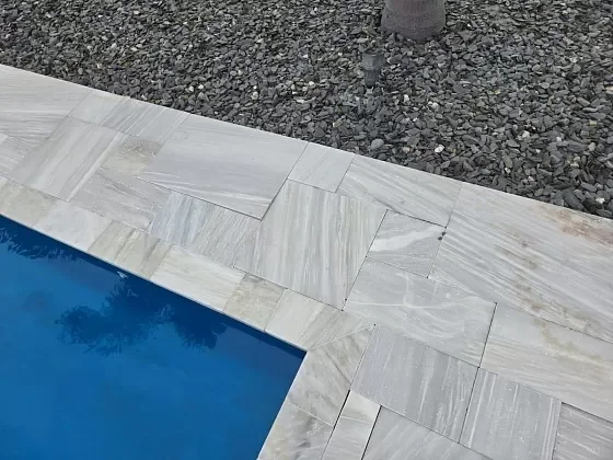 Pool deck paver edge detail showing clean lines after installation in Palm Beach, FL