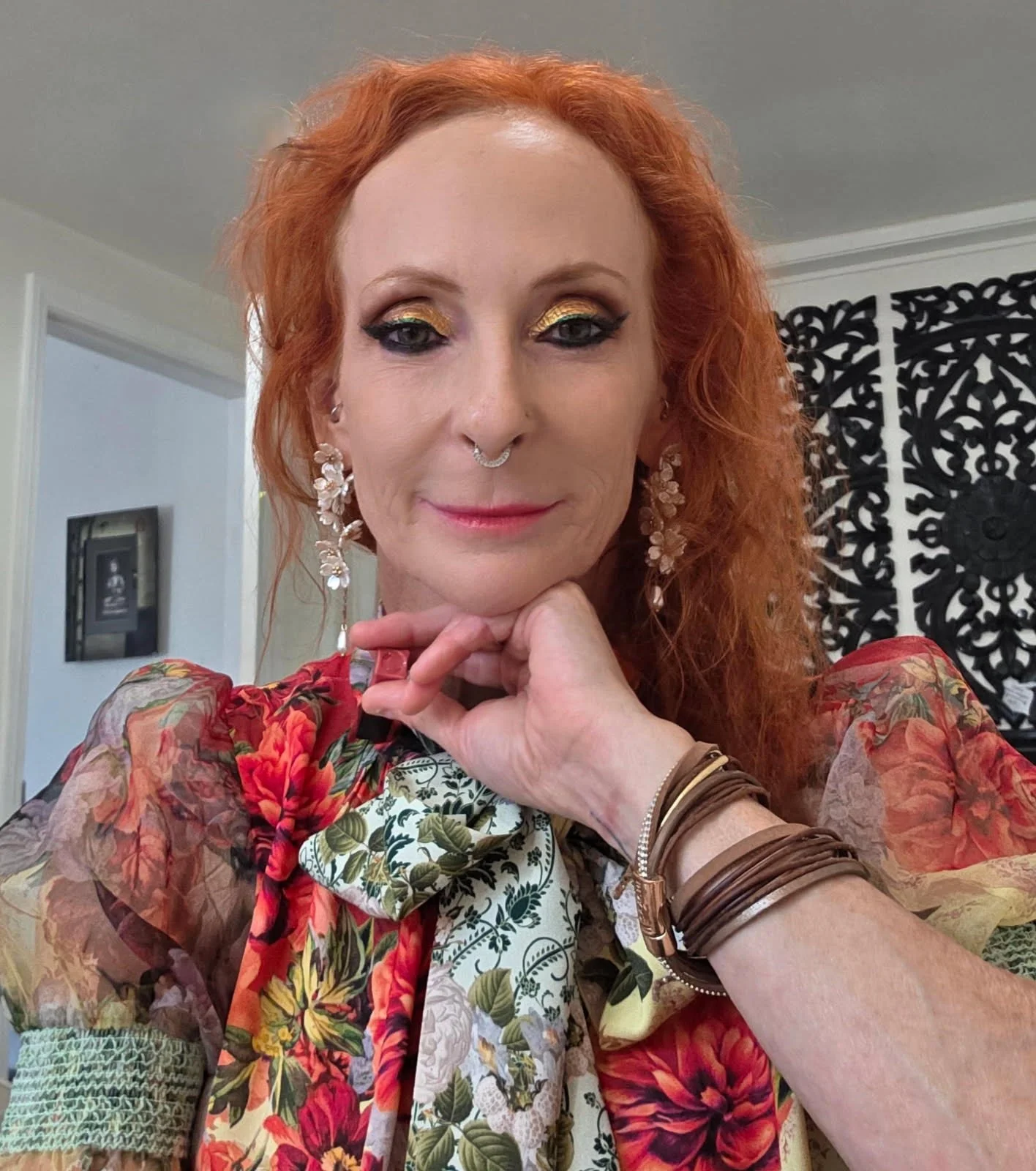 Heather Balog of Better with Heather, smiling softly with her hand resting beneath her chin.