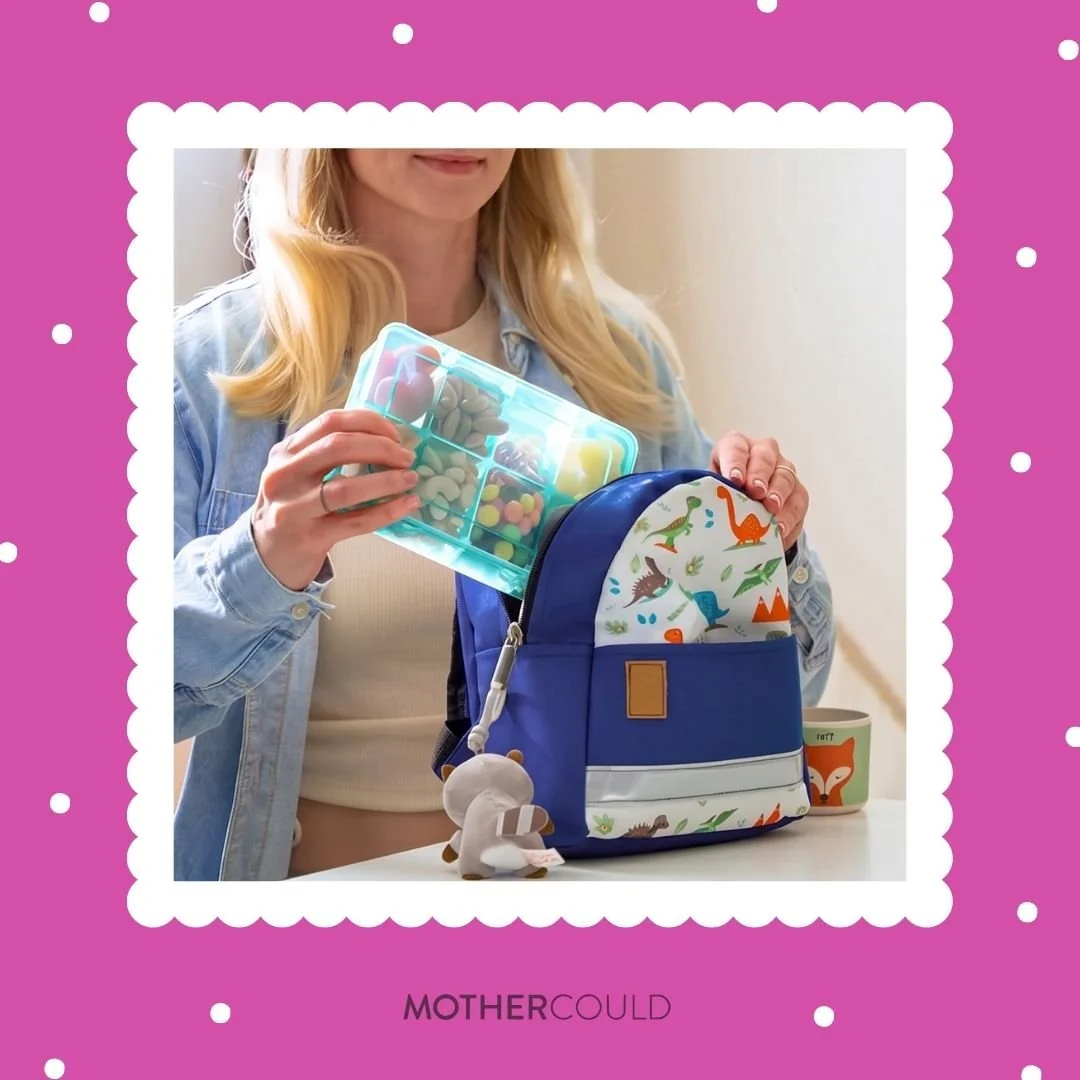 Mom putting Mothercould snack box into kid's backpack for travel