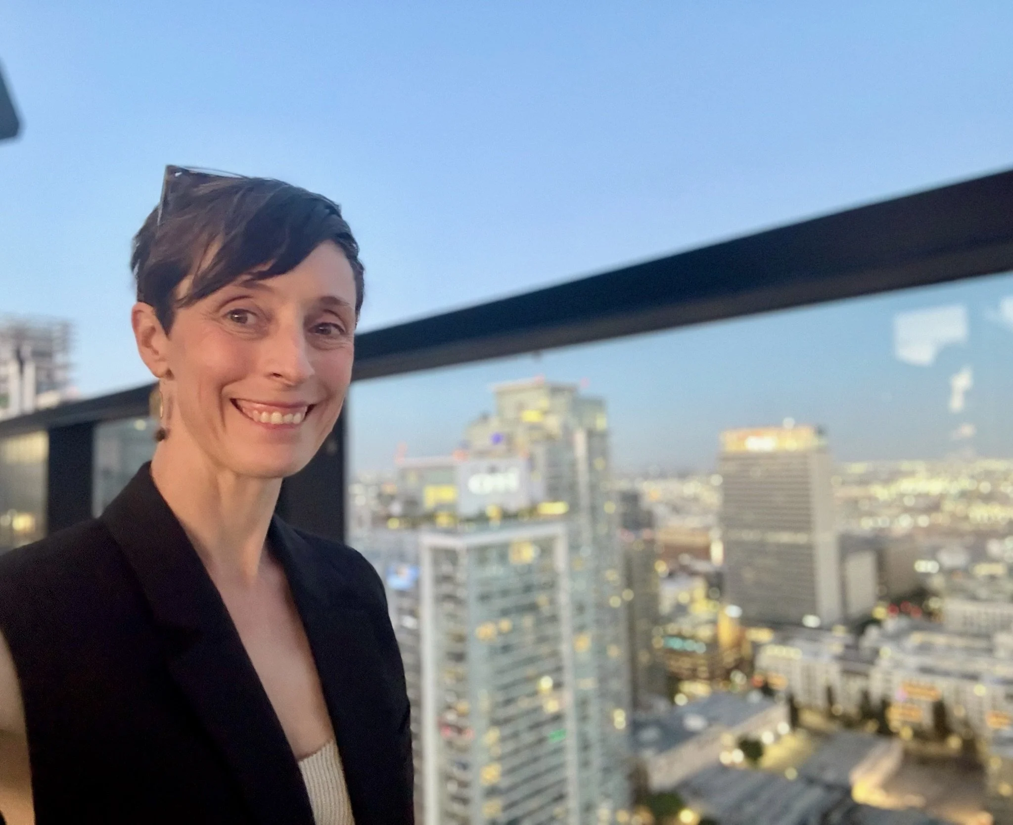 Selfie of Dr. Brown from a rooftop patio with Los Angeles buildings in the background. As a highly sensitive person, it can be hard to be in big cities at busy conferences, but there are ways to manage overwhelm.