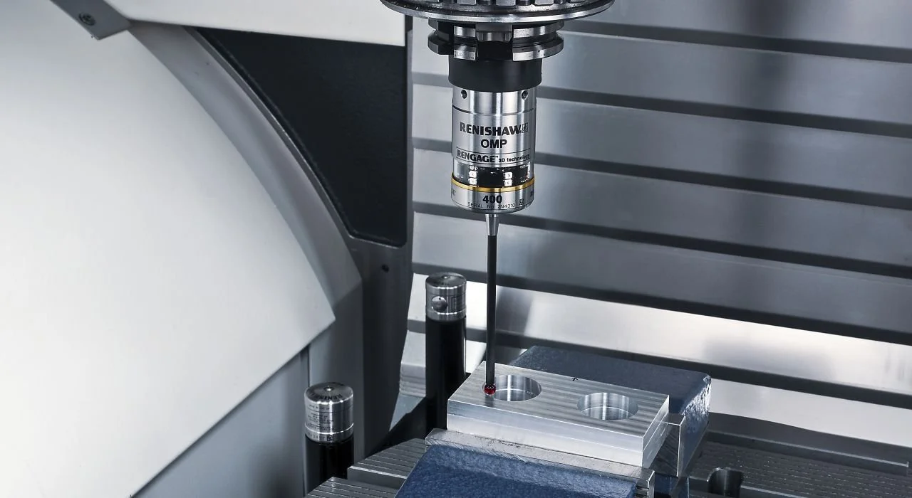 Close-up of a CMM machine performing a precision measurement or drilling operation on a metal component.