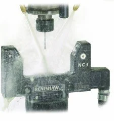 A Renshaw NC3 milling machine with coolant and drill bits in a workshop setting.