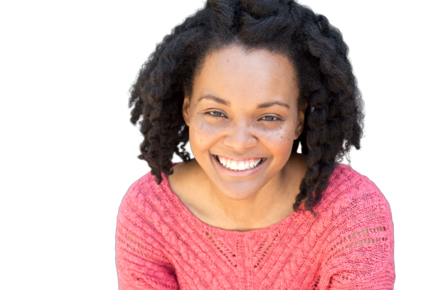 Smiling woman with curly hair wearing a pink sweater
