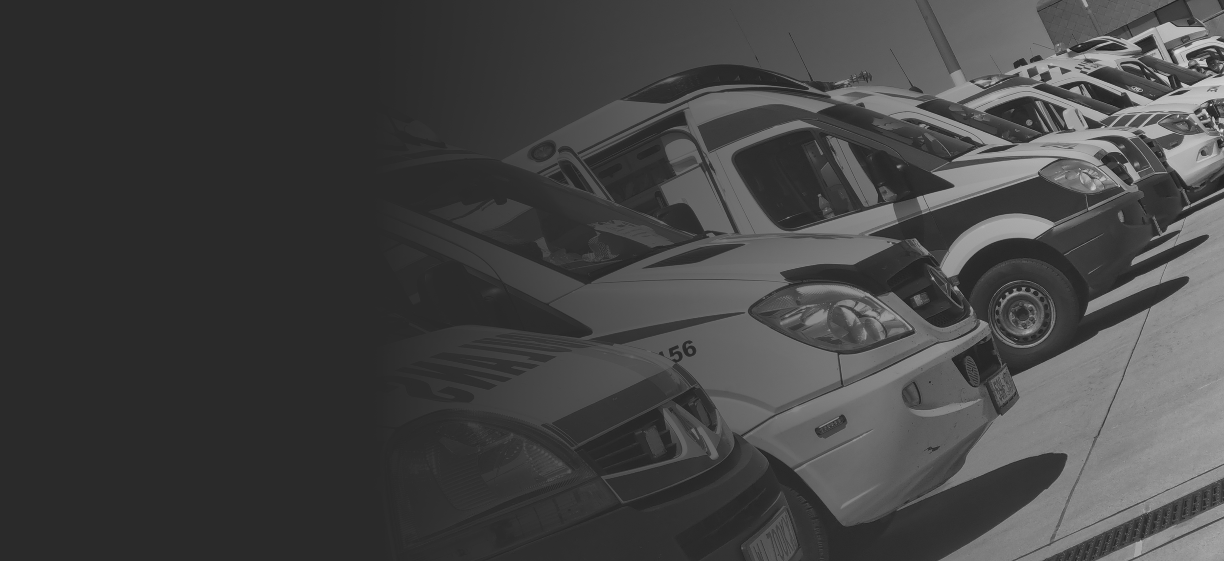 Black and white image of an airport runway filled with various ambulances in Poland.