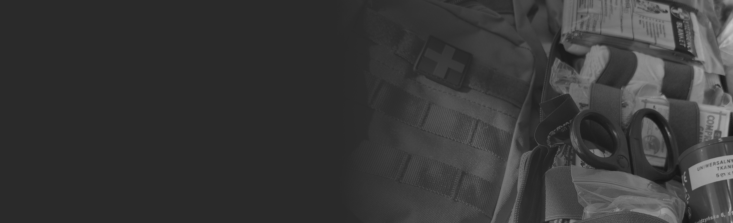 IFAK kit with medical supplies, including scissors, gauze, and antiseptic wipes, placed next to a tactical bag.