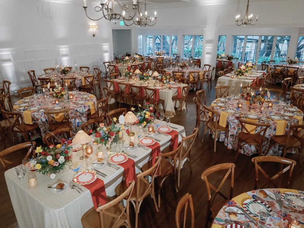 Mattie's banquet hall decorated with floral centerpieces, candles, and table settings for a celebration or wedding reception.