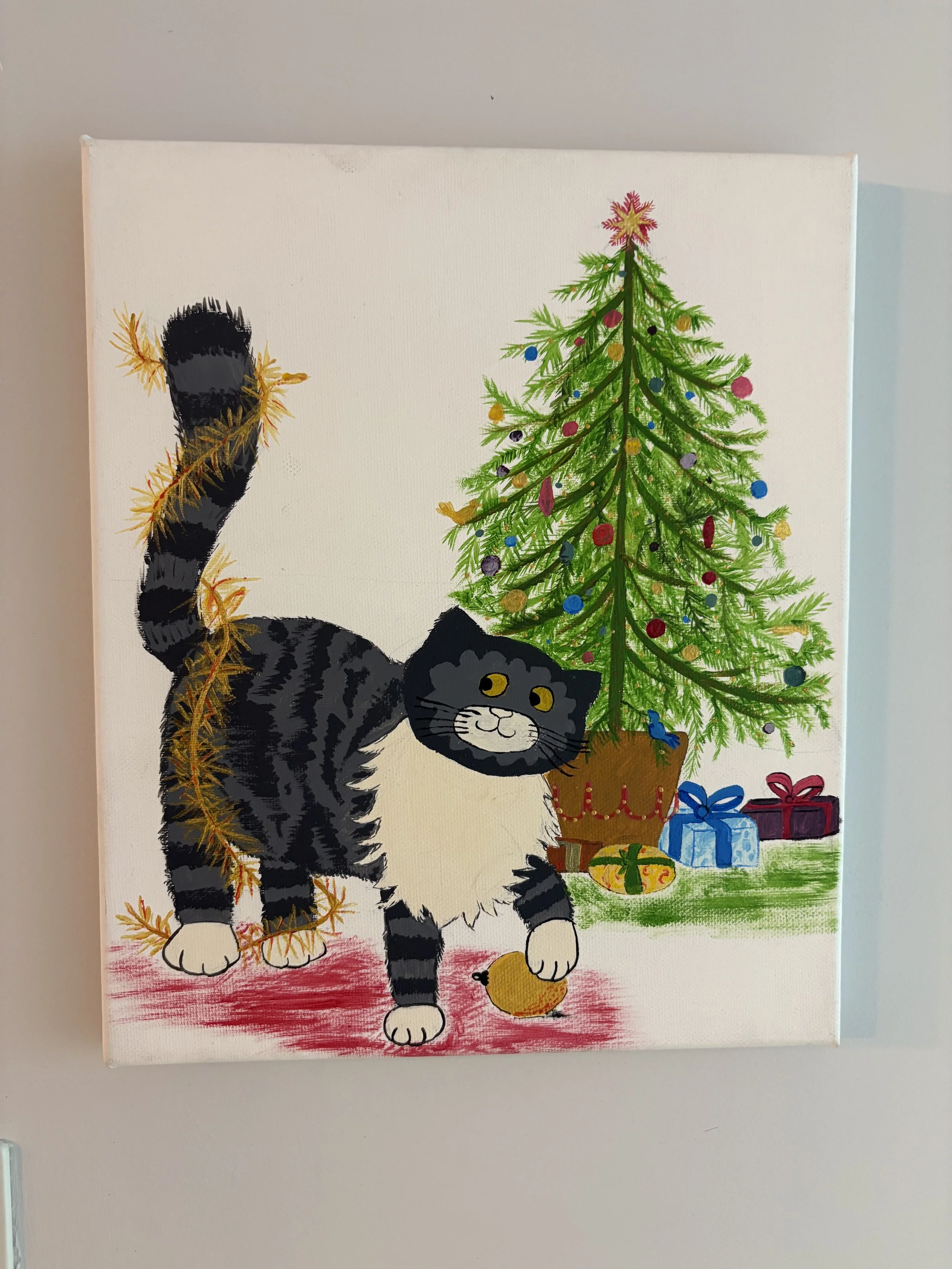 Acrylic on canvas Painting of a black and white cat with yellow eyes (Mog the Cat from books) standing next to a decorated Christmas tree with presents underneath. Depicts cover of Mogs Christmas storybook