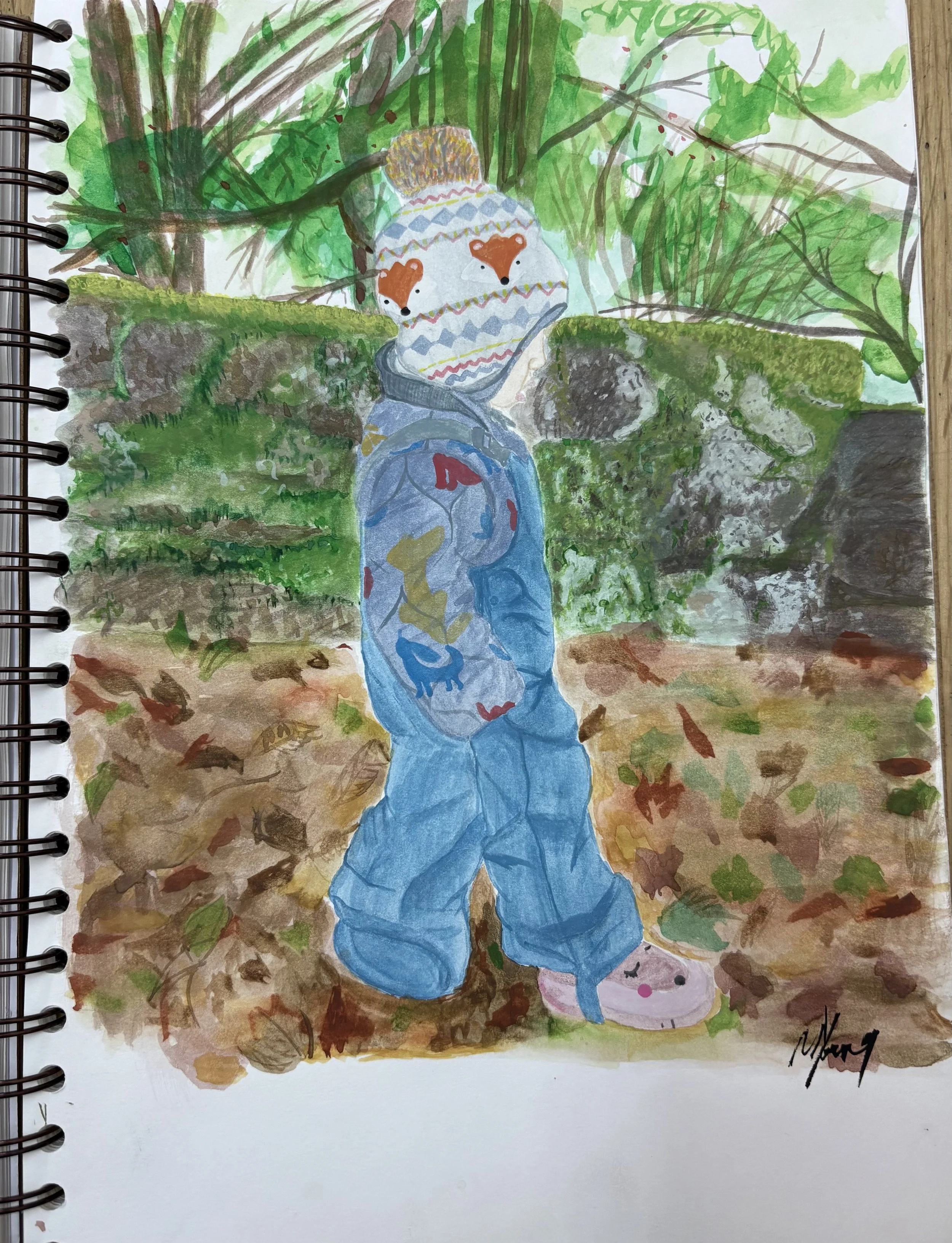 Watercolour of a young child standing outdoors on a fall day, wearing a colourful knit hat with animal faces, a blue jacket with animal prints, and pink shoes. The background features green foliage, rocks, and fallen leaves.