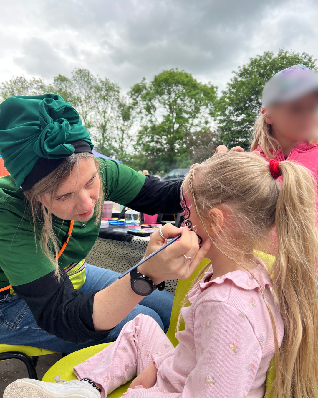 Face painting children at a fair