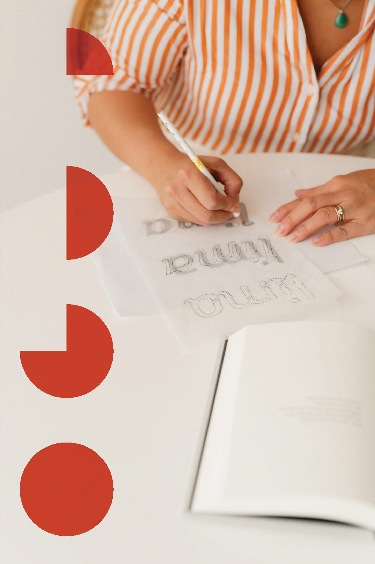 Person writing on paper with a pencil, creating a decorative word art that says 'Thank you'.