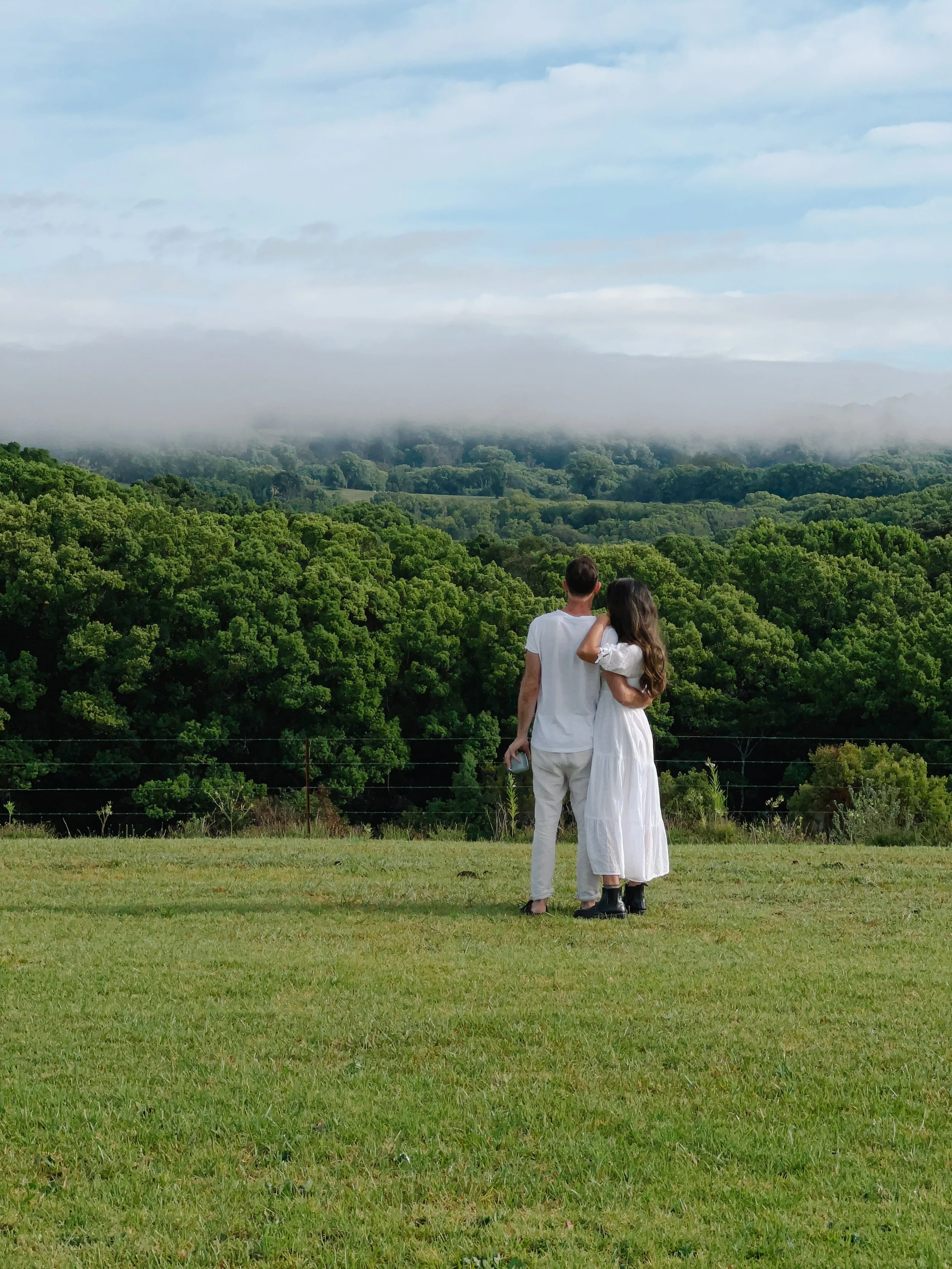 Couple overlooking lush valley views at a private retreat venue in the Byron Bay Hinterland