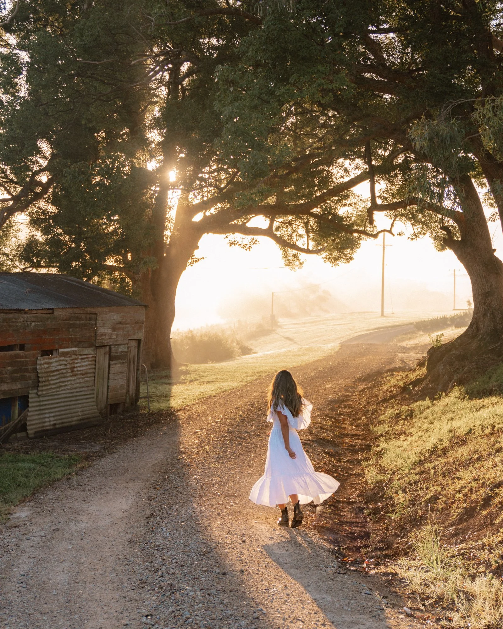 Guest walking along a quiet country road at sunrise at a luxury retreat in the Byron Bay Hinterland