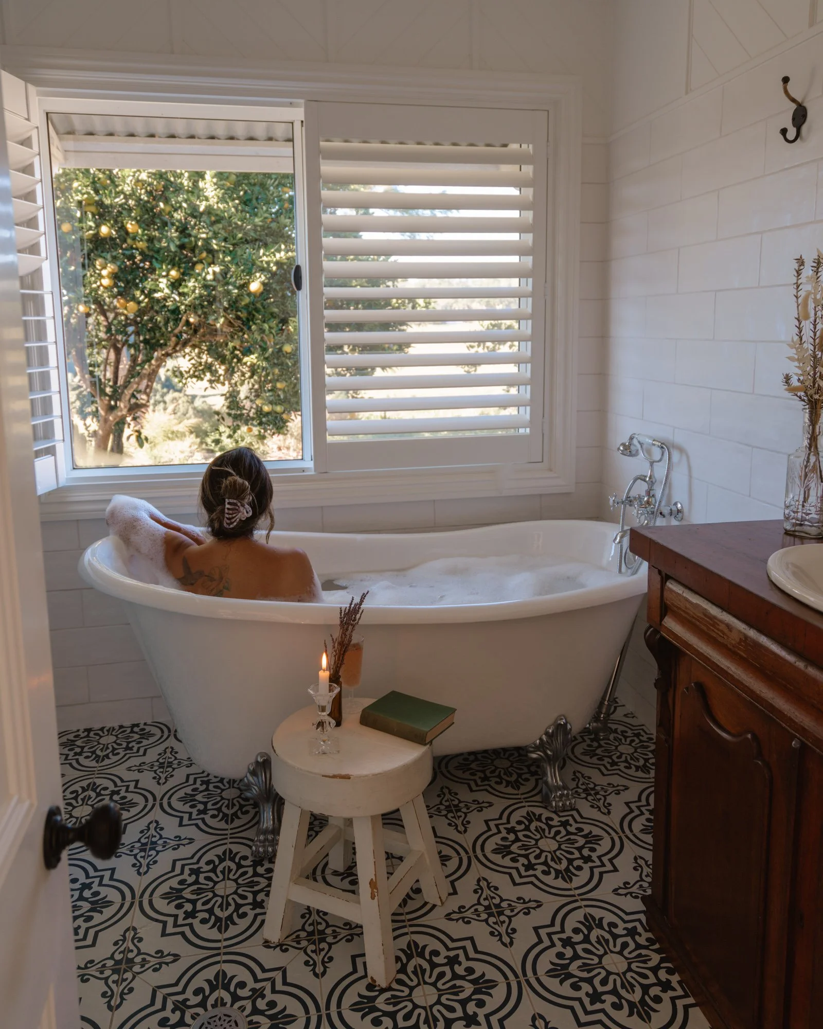 Luxury private wellness retreat guest relaxing in bath overlooking nature at Heartwood Farm Byron Bay Hinterland