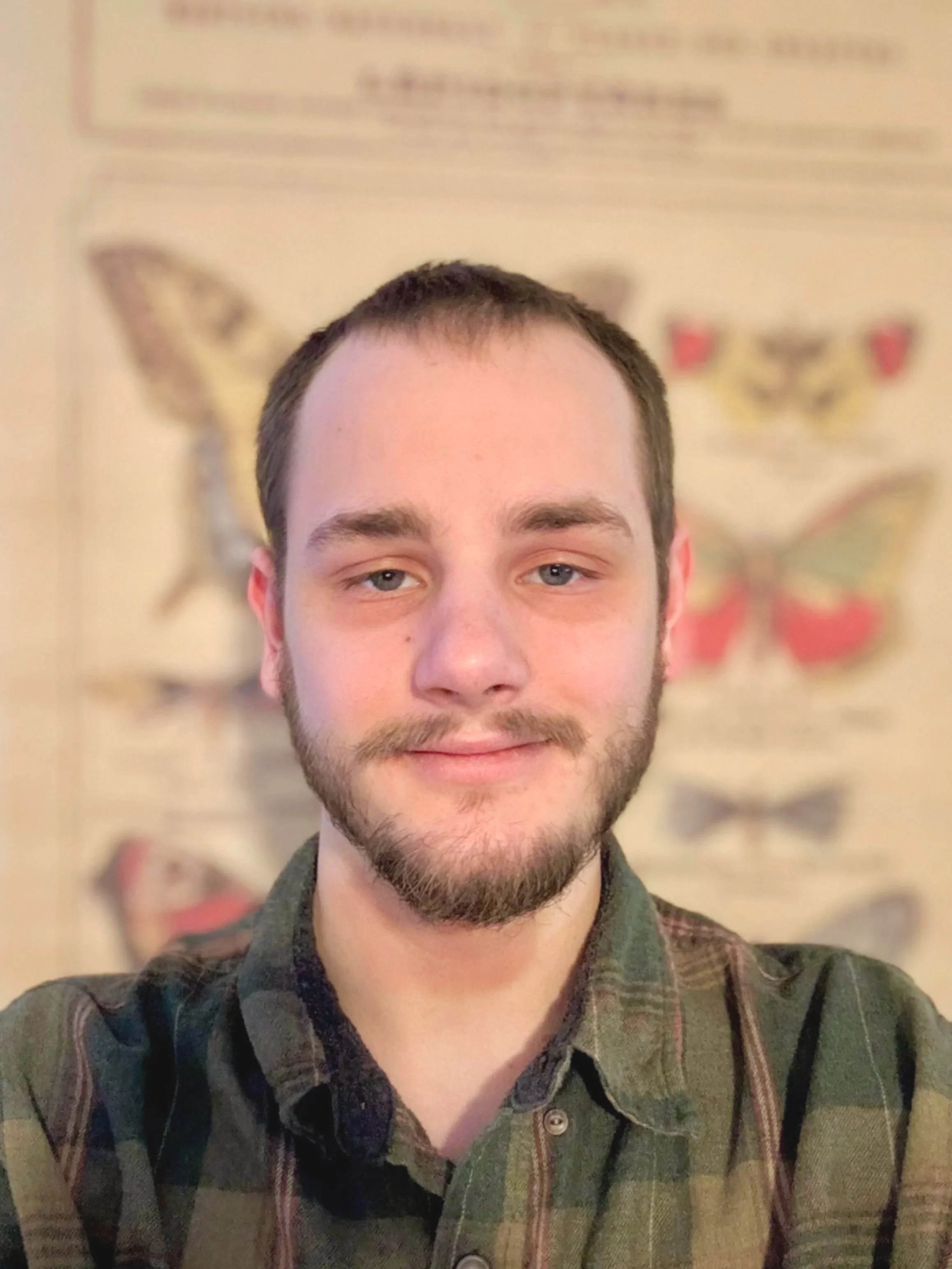 Image of Jack Huckabay, insect specialist- a young man with a beard and a kind smile