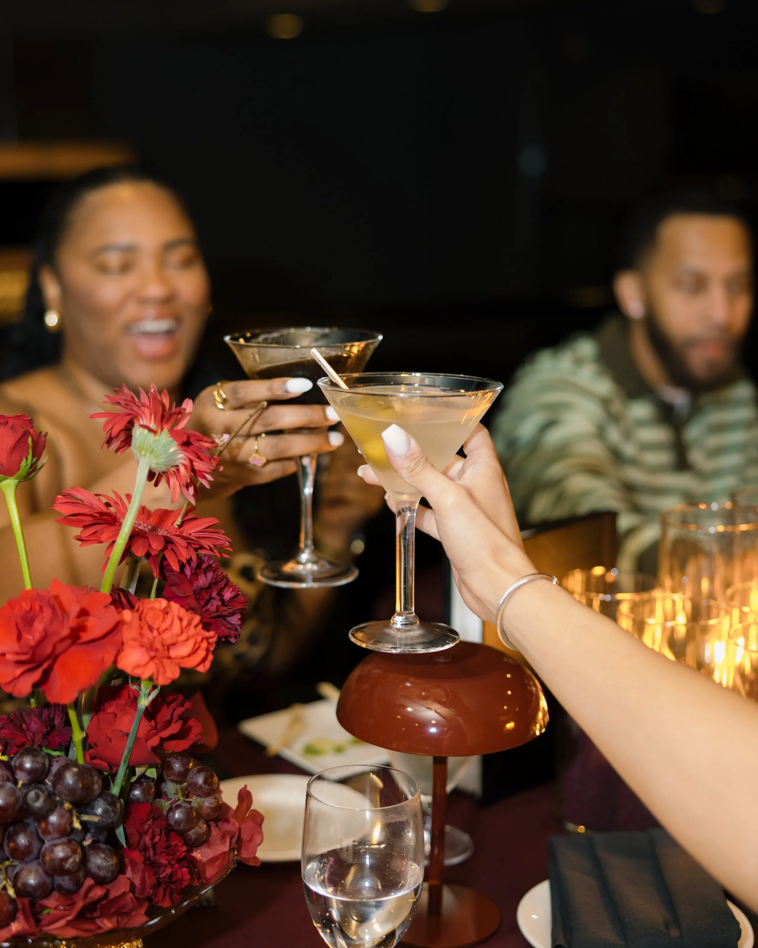 Two women holding cocktails