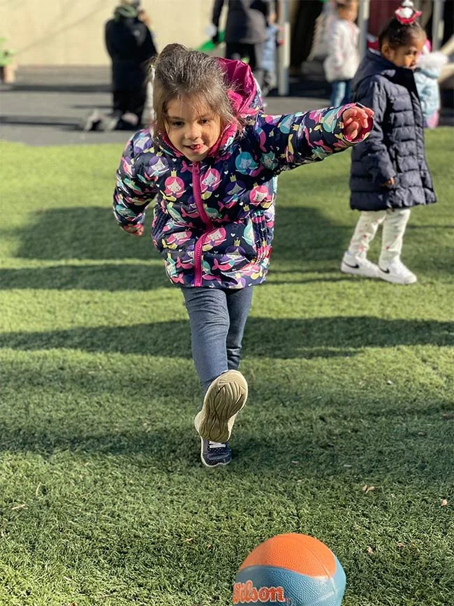 Child kicking ball