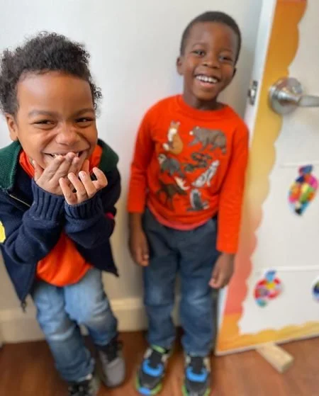 Two PNS kids smiling and laughing at camera
