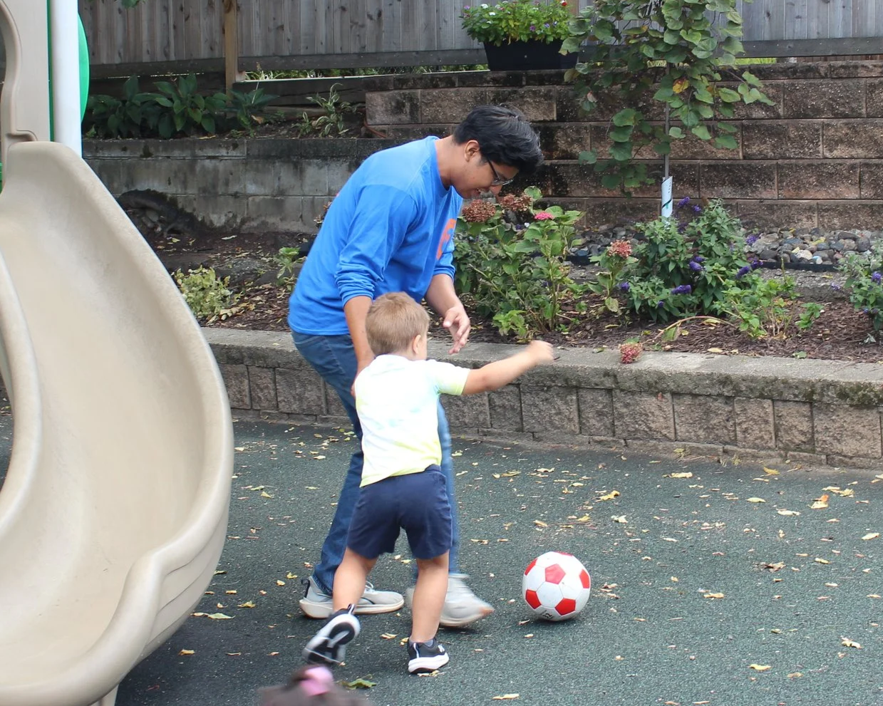 Two PNS children playing outside on playground