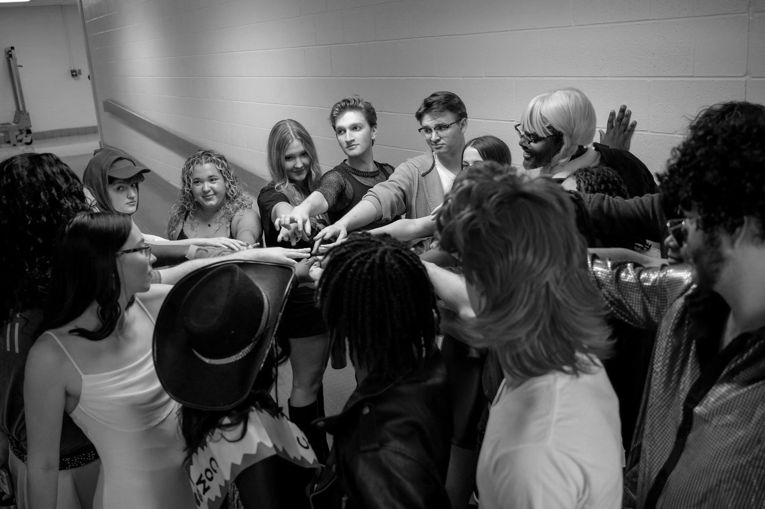 Low Key Acapella backstage at their Fall 2025 concert, "The Gramm-Keys", doing a team bonding exercise.

Photo Source: Landon Shackelford