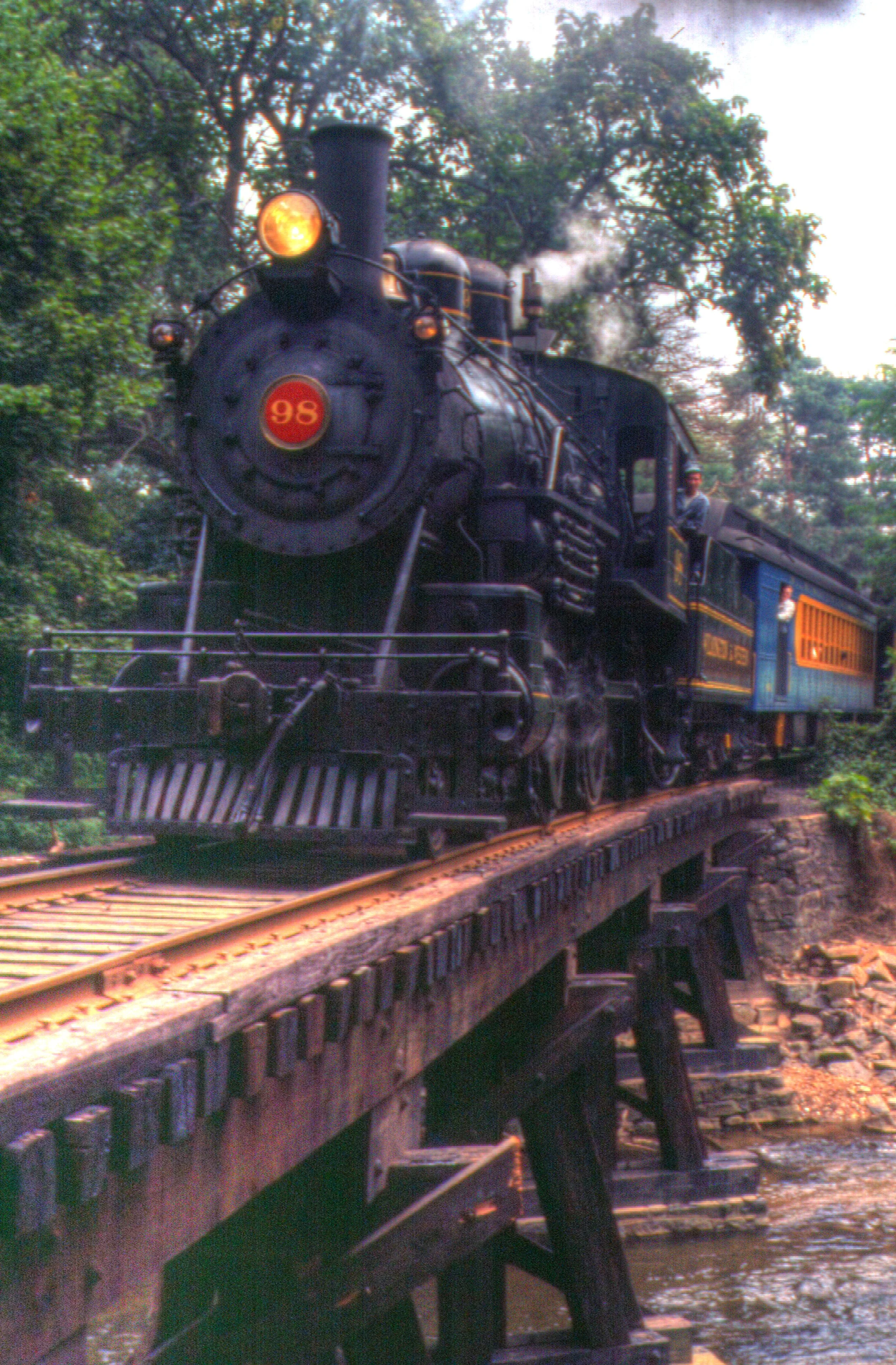 Steam train crossing trestle