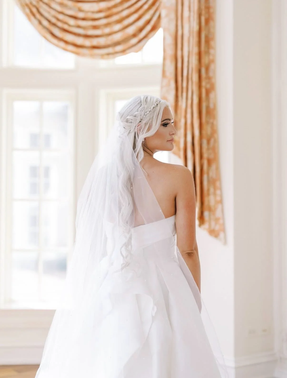 From radiant glow and sophisticated low updos to soft glam and romantic half-up details, our artistry enhances the unique beauty of every bride. This carousel showcases the beautiful spectrum of our work, whether complementing vibrant florals, tradit