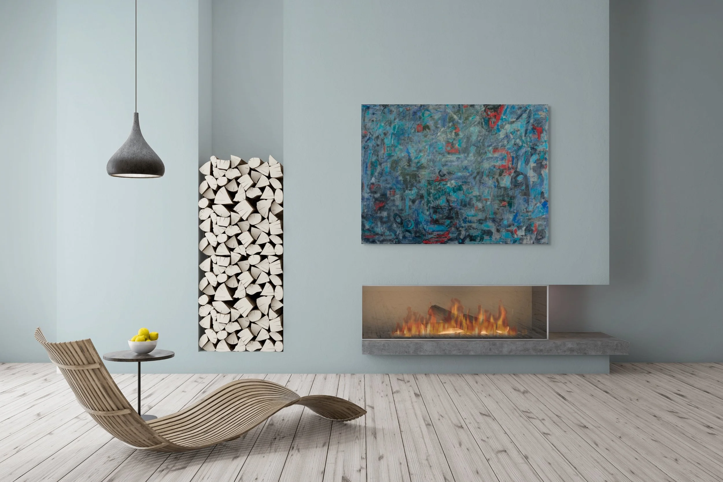 Modern living room with light gray wall, abstract blue painting, built-in fireplace with flames, stack of cut firewood, wooden lounge chair, small round table with a bowl of green apples, and a hanging gray pendant lamp.