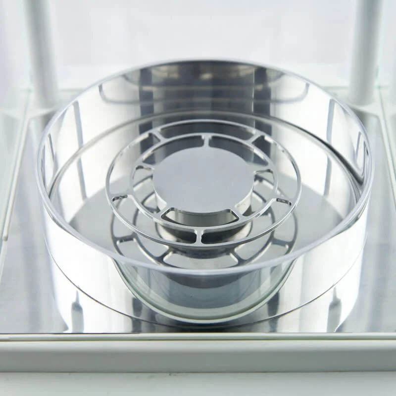 Empty stainless steel microwave turntable inside microwave oven.
