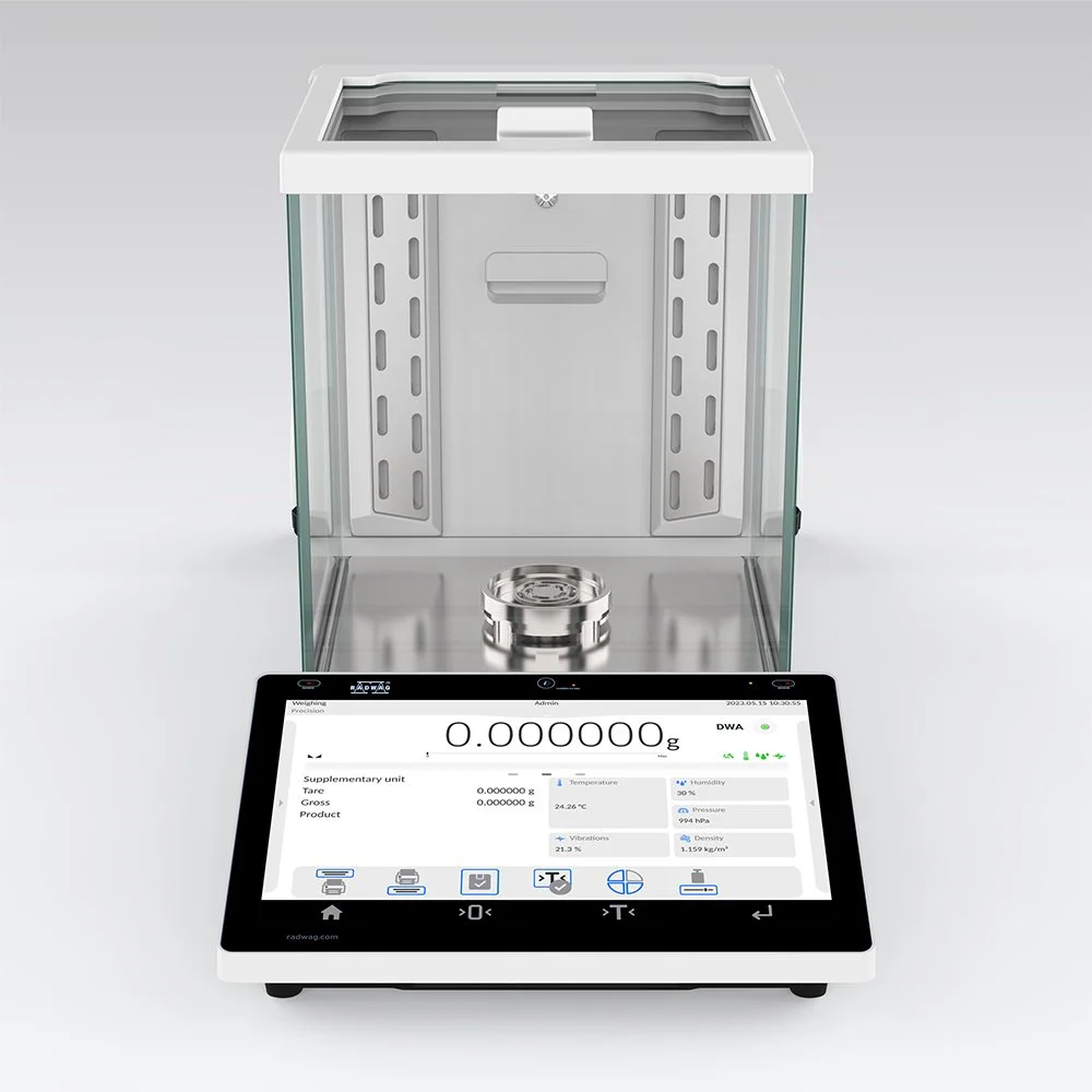A digital scale with a glass enclosure for weighing items, showing 0.00000 grams, with various measurement options displayed on the screen.