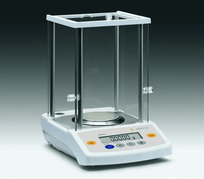 A digital laboratory balance scale with a glass enclosure and metal rods, used for precise measurements in scientific experiments.