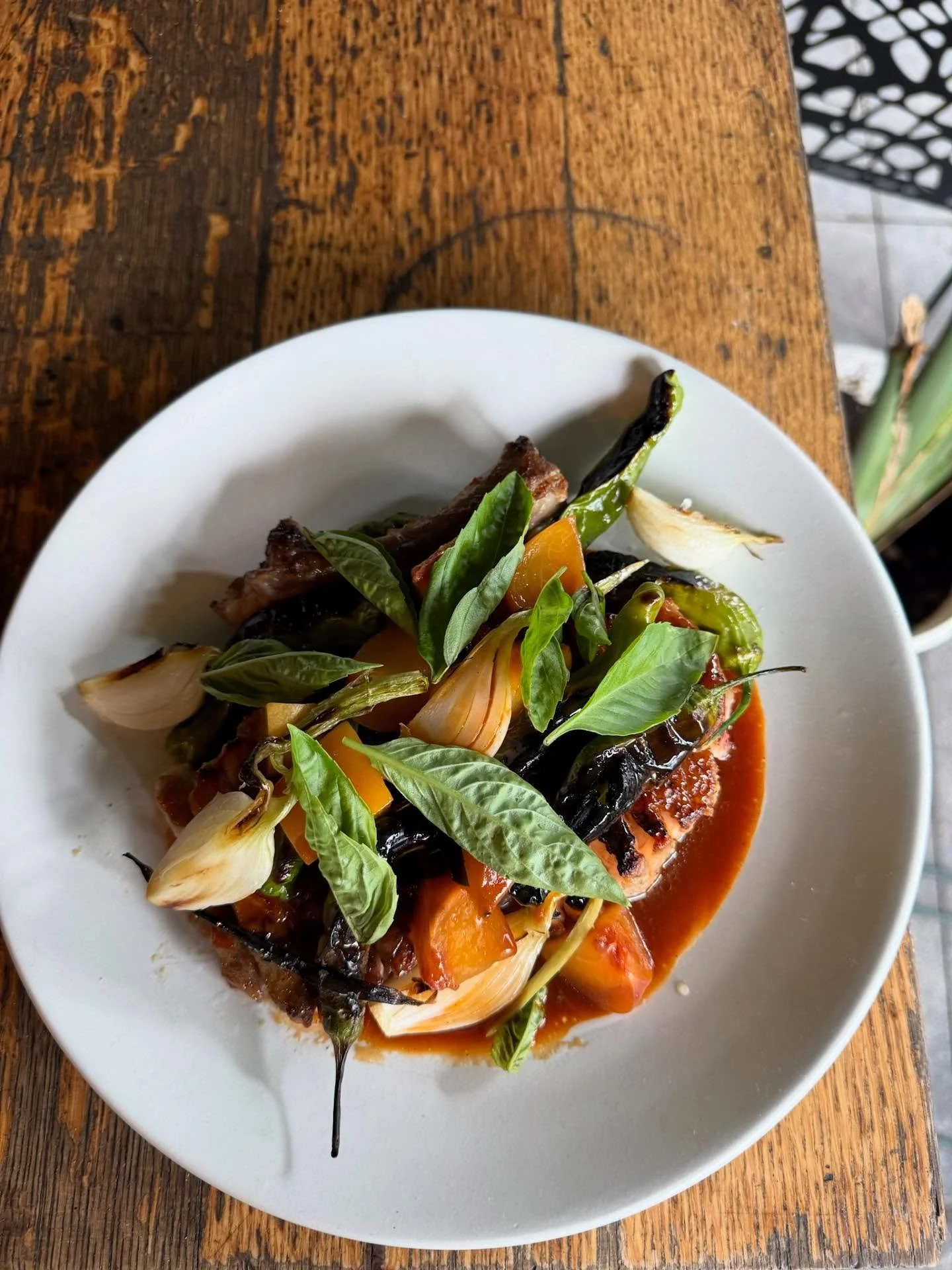 Our BBQ Pork chop in all its end of summer glory. Peaches, shishito peppers, red pepper vinaigrette, Garden basil. Sounds straightforward but read on 👇

The secrets to this juicy heritage Berkshire pork chop:

Hot on the grill it&rsquo;s lacquered w