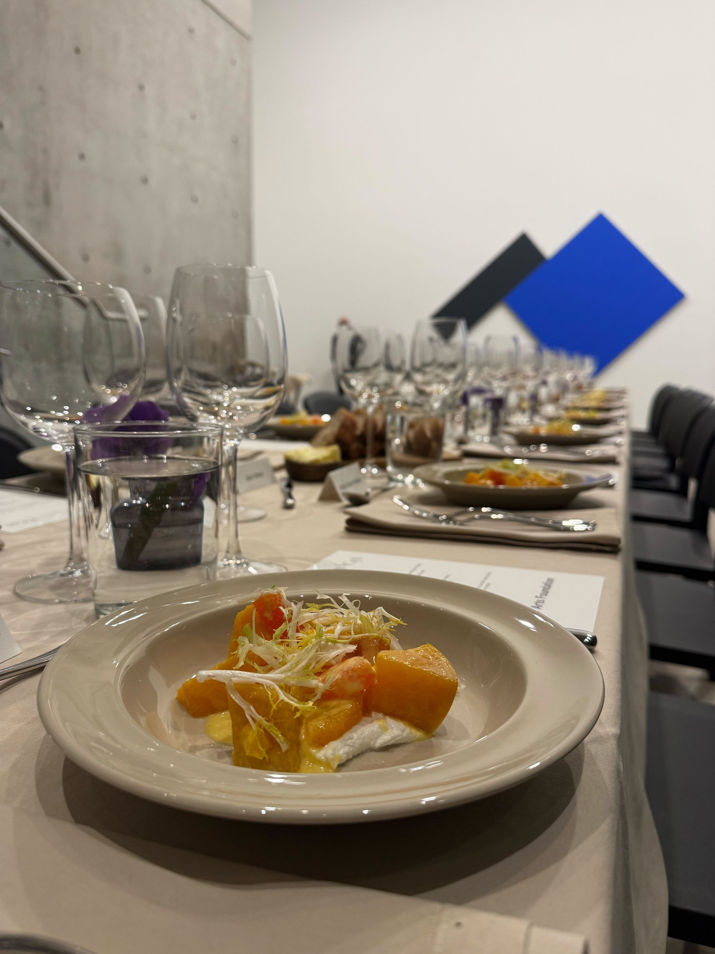 dinner table set with glasses, plates and dessert at a private event catering